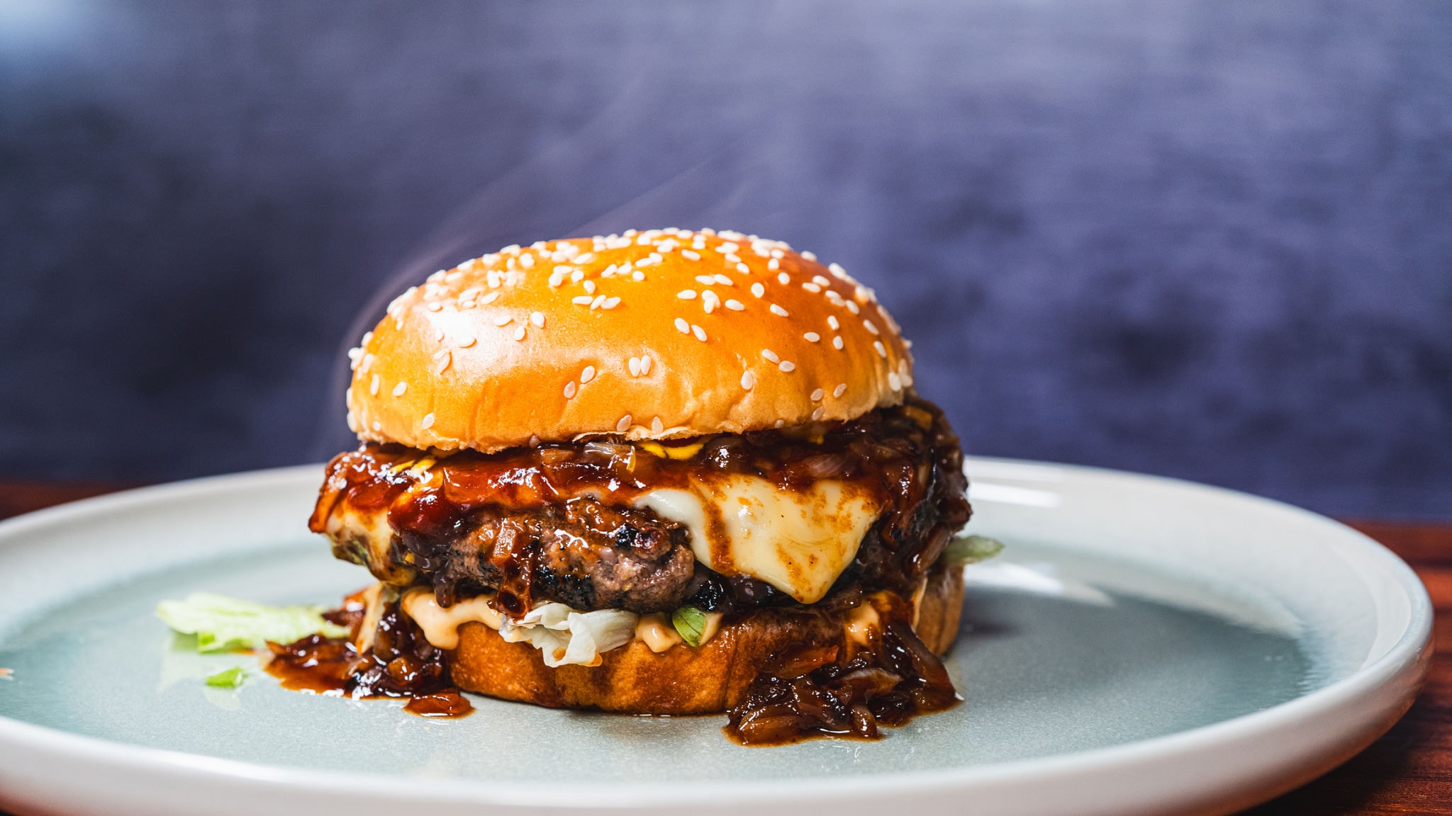 Gourmet BBQ burger with melted cheese and caramelized onions