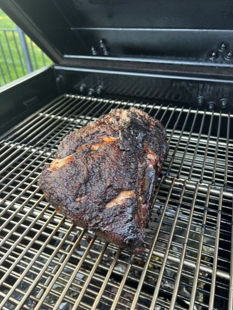 Brisket smoking on grill grates